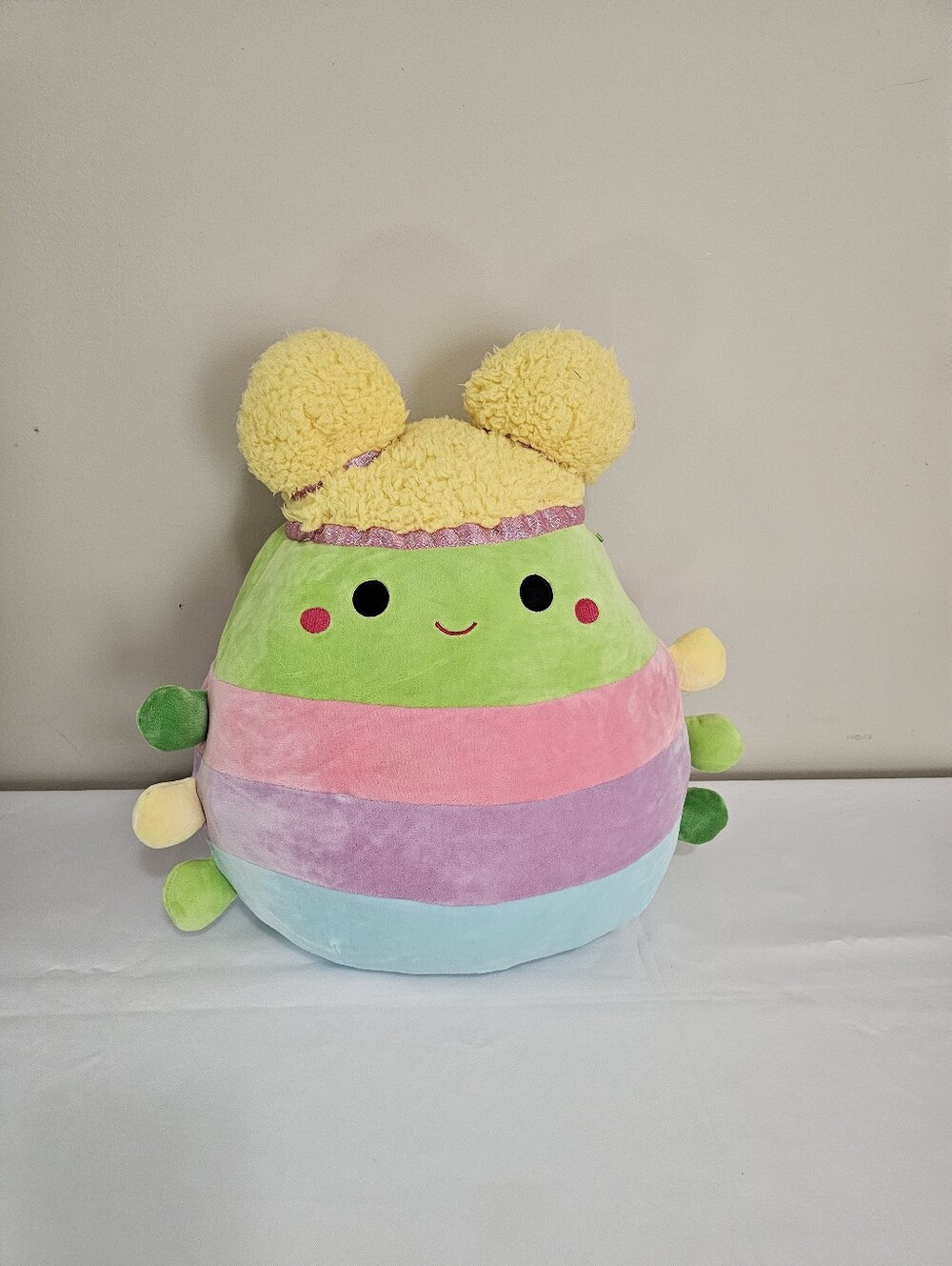 Squishmallows Rainbow Striped Bug Plush with Yellow Pom Hat